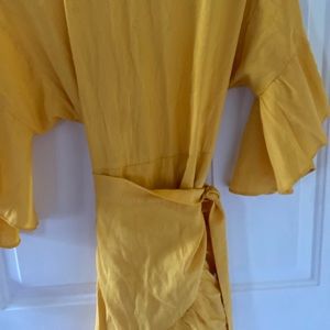 Women summer yellow dress with wrapping skirt round the waist .